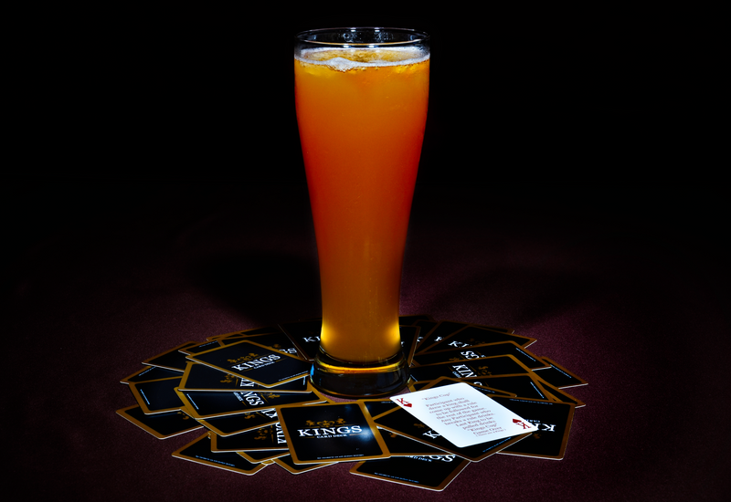 Cards around a pint glass with a mystery drink, ready for ring of fire.