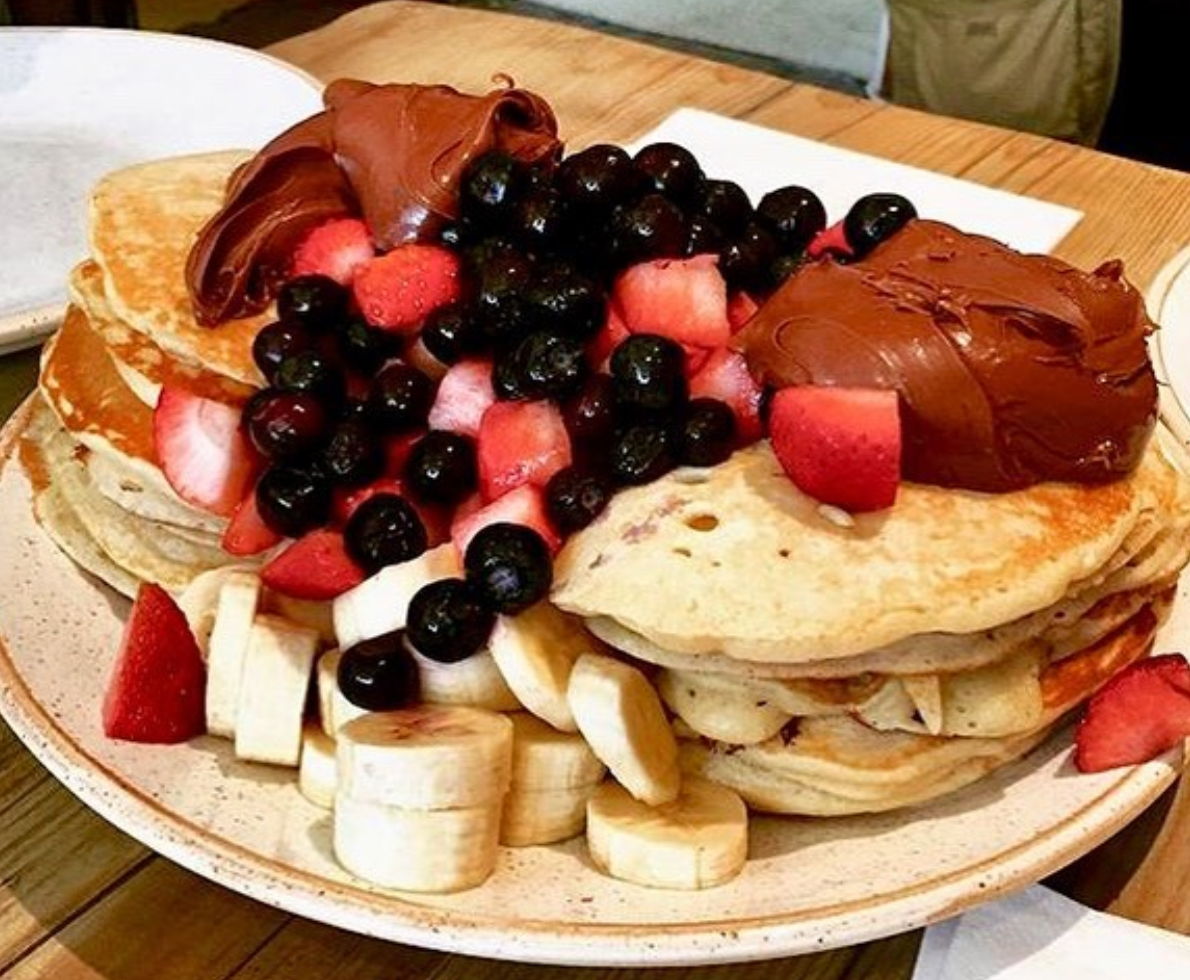 stack of pancakes with various toppings
