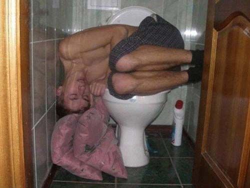 man passed out on the toilet sideways