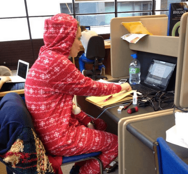 student in library in a onesie