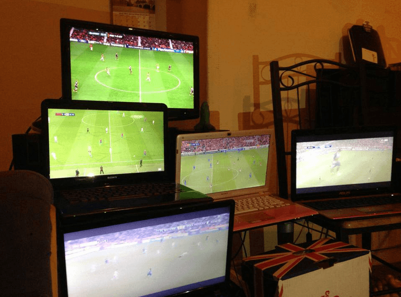 loads of screens showing the same football match