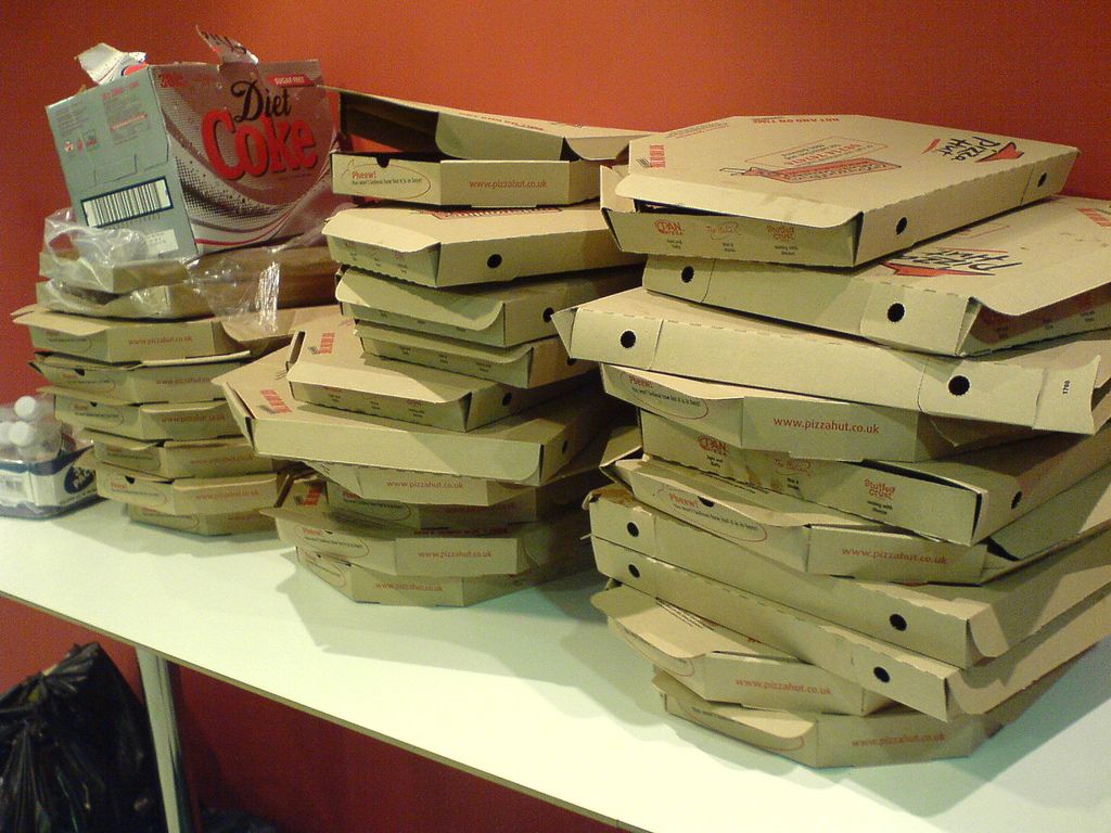 Three stacks of empty pizza boxes