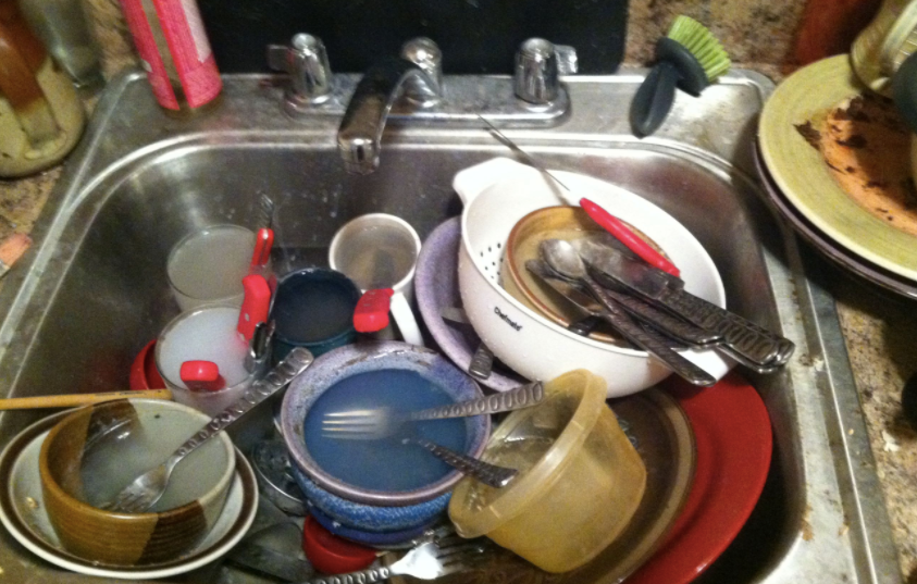 sink full of dirty plates