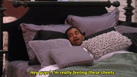 Parks and Recreation Gif. Man in bed saying 'Hey guys! I'm really feeling these sheets'