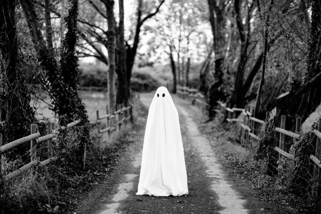 person in a white sheet as a ghost